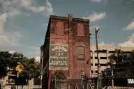 brick building camera:fujifilm_x100 car city exterior fence metal orientation:landscape photographer:deaddeaddeath sign vehicle // 1728x1152 // 362KB