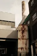brick building camera:fujifilm_x100 exterior metal orientation:portrait photographer:deaddeaddeath rust smokestack storage_tank // 1152x1728 // 218KB