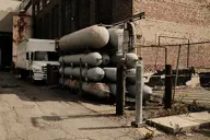 asphalt brick camera:fujifilm_x100 canister exterior fence industrial metal orientation:landscape photographer:deaddeaddeath rust vehicle // 1728x1152 // 446KB