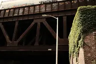 brick bridge camera:fujifilm_x100 exterior industrial ivy metal orientation:landscape overgrown photographer:deaddeaddeath plant rust train utility_pole // 1728x1152 // 317KB
